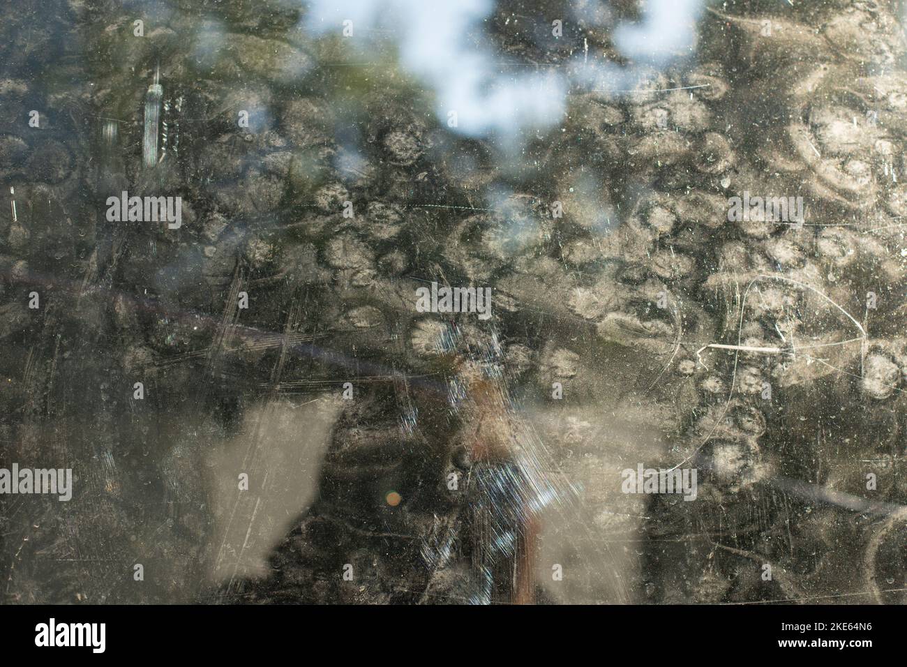 Dirty mirror on street. Reflection in turbid glass. Prints on surface. Stock Photo