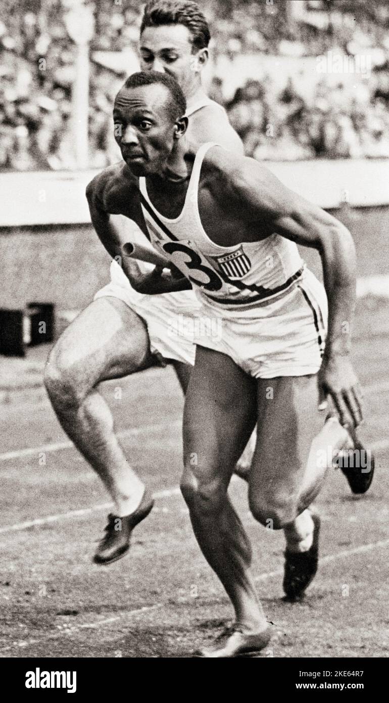 Jesse Owens and teammate competing in the 400 meter relay at the Berlin