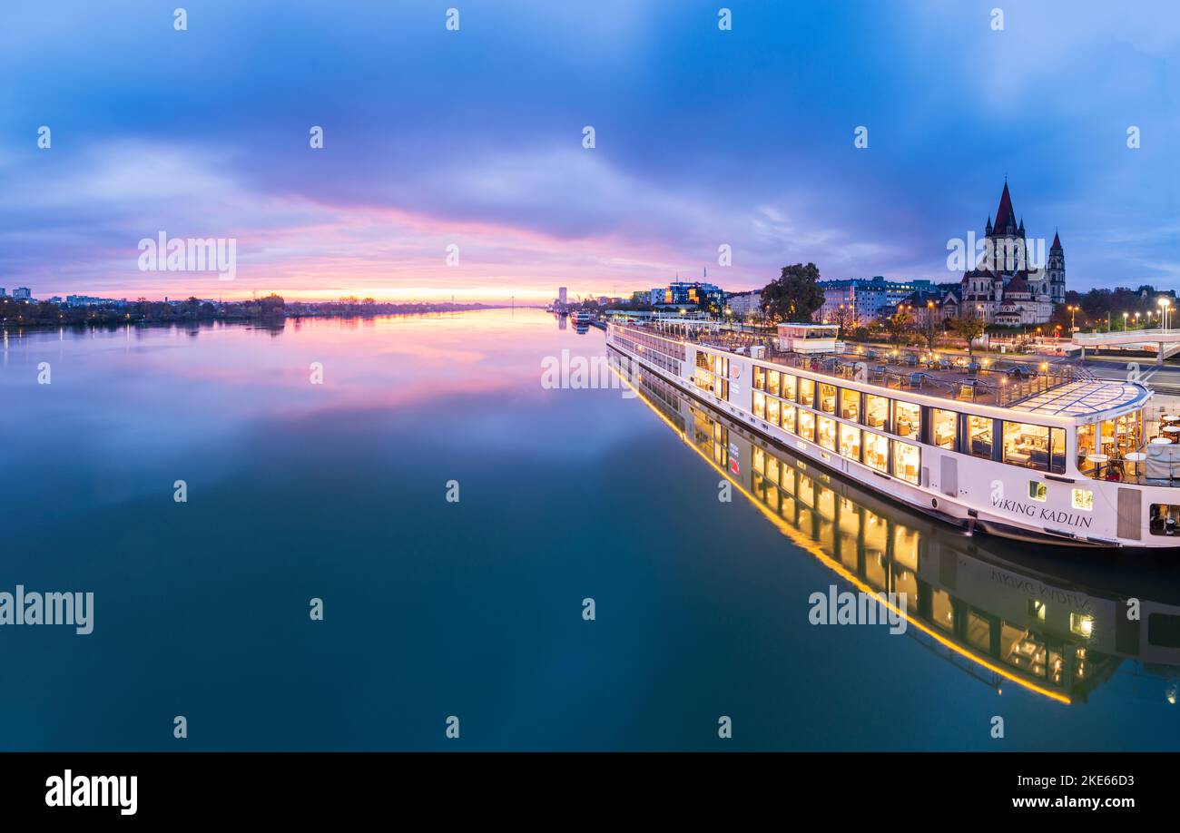 Wien, Vienna river Donau (Danube) at sunrise, cruise ship at dock at