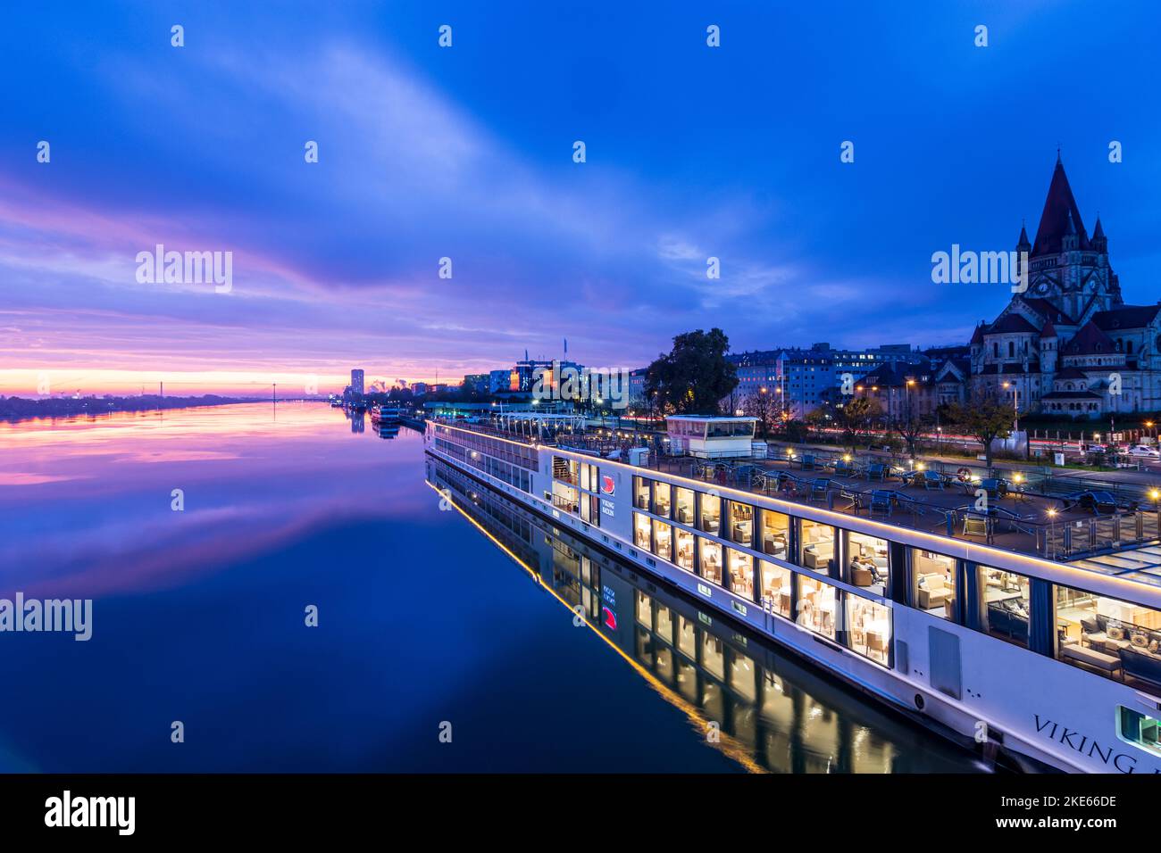 Wien, Vienna river Donau (Danube) at sunrise, cruise ship at dock at