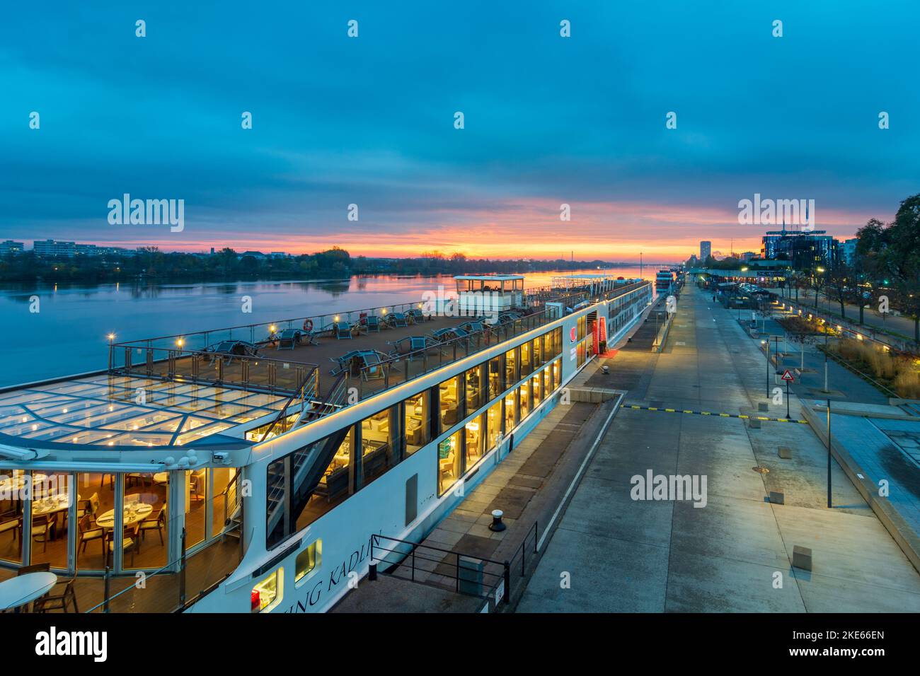 Wien, Vienna river Donau (Danube) at sunrise, cruise ship at dock at