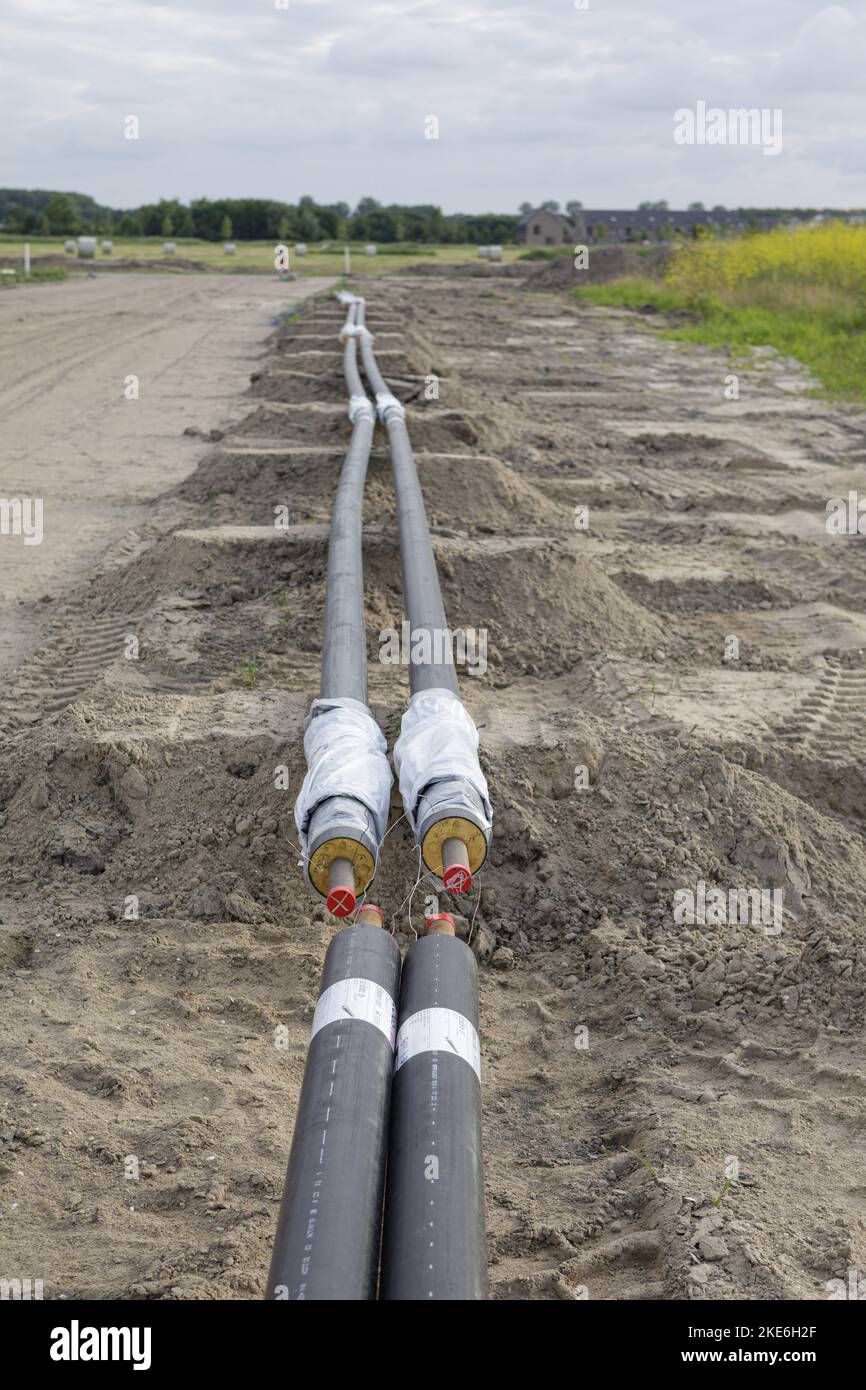 A Closeup of irrigation pipes in a muddy field Stock Photo - Alamy
