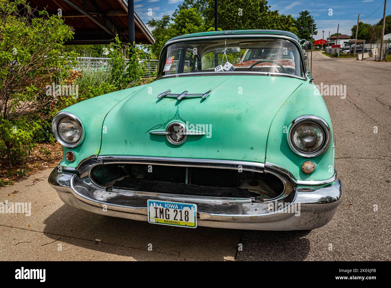 Des Moines, IA - July 02, 2022: Low perspective front view of a 1955 Oldsmobile 88 4 Door Sedan at a local car show. Stock Photo