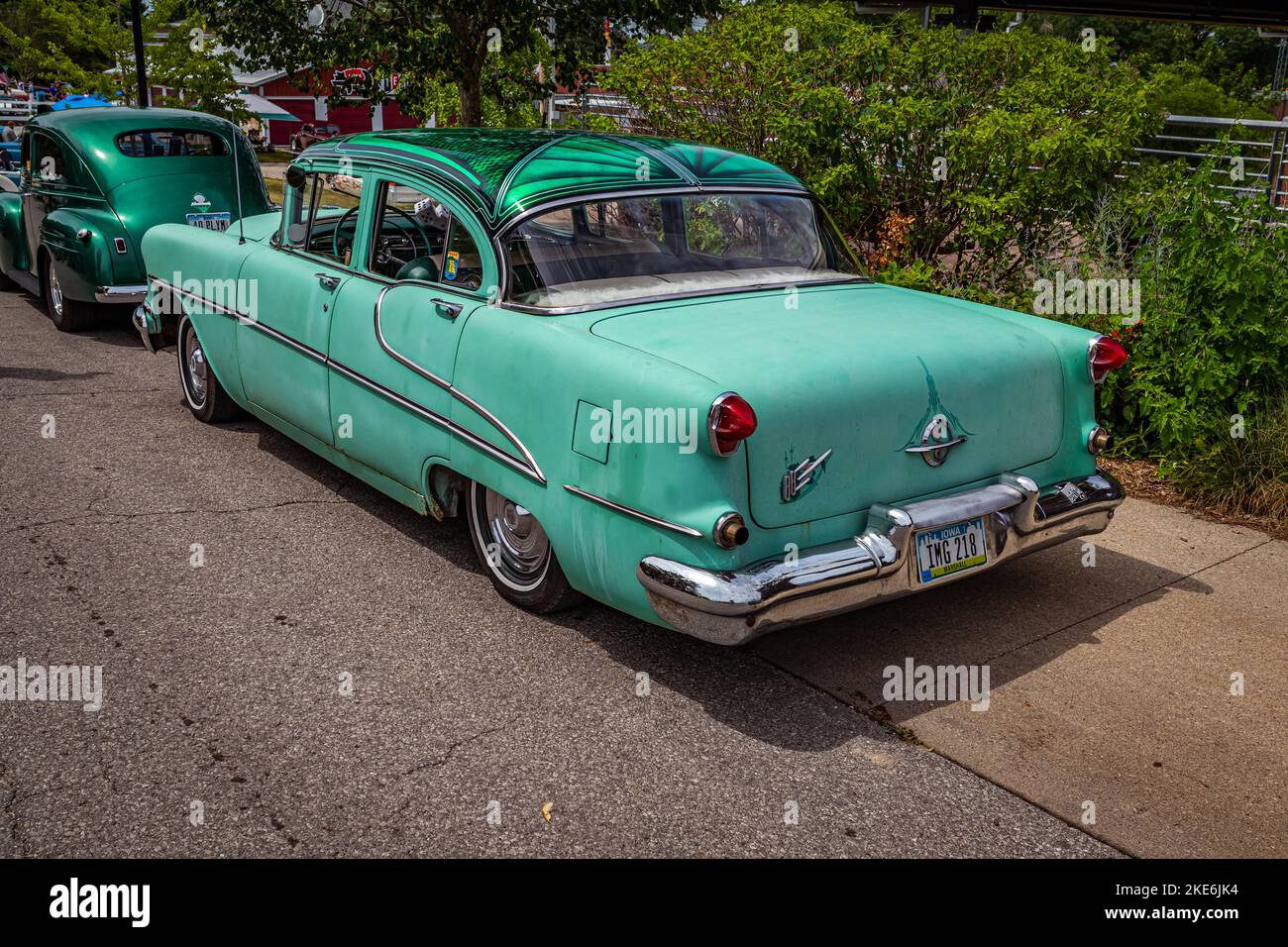 Des Moines, IA - July 02, 2022: High perspective rear corner view of a 1955 Oldsmobile 88 4 Door Sedan at a local car show. Stock Photo