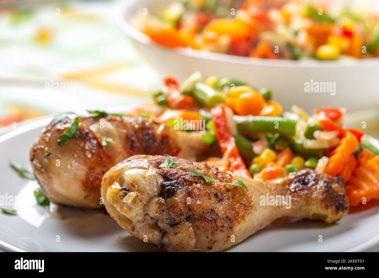 Grilled chicken legs with vegetables - close up view Stock Photo