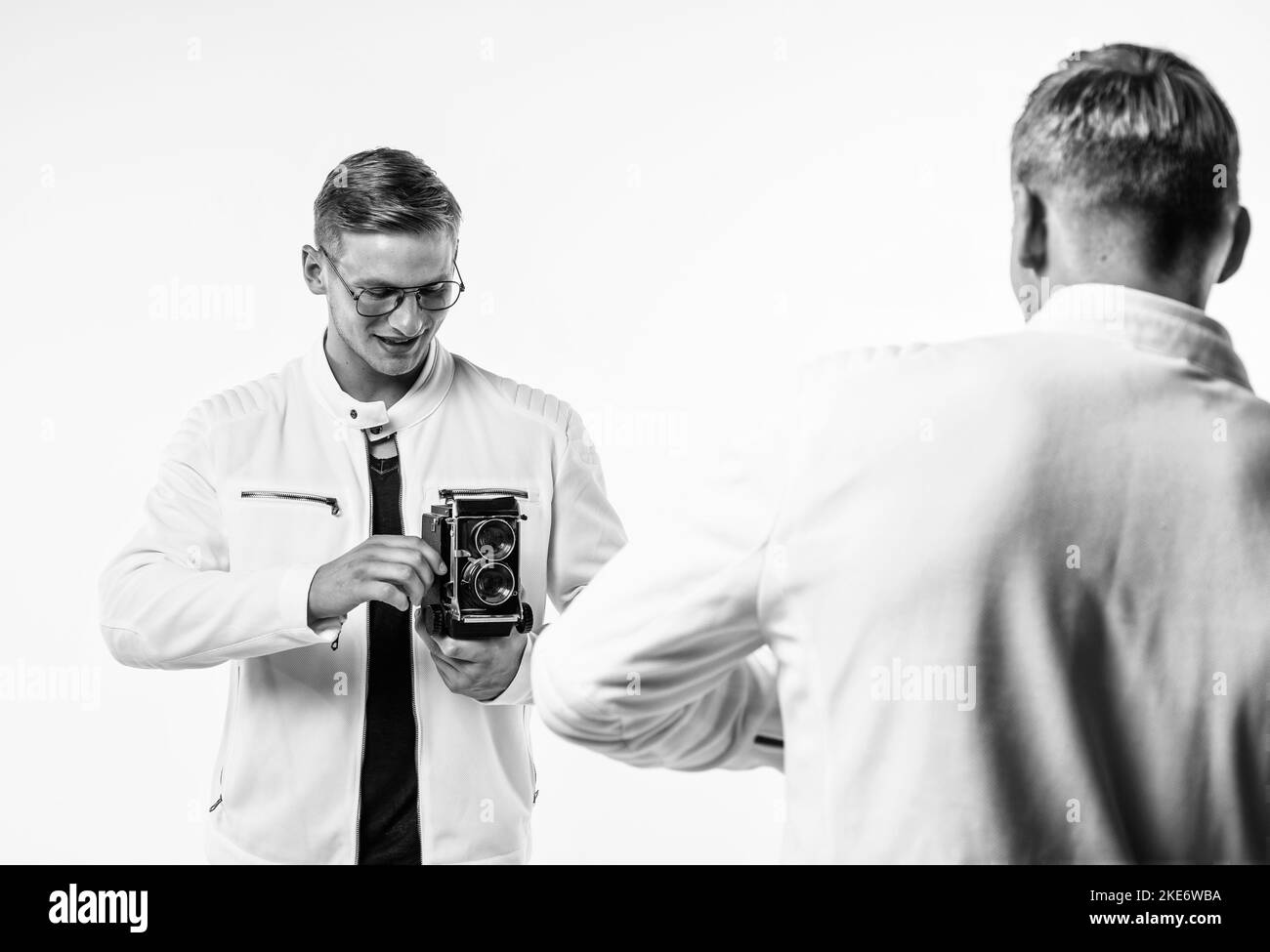young twin brothers photographer with similar appearance make photo