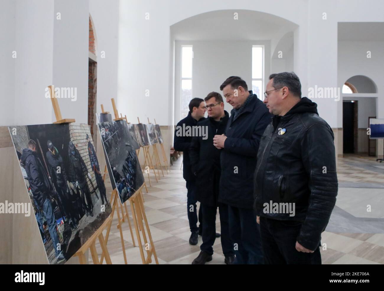 BUCHA, UKRAINE - NOVEMBER 10, 2022 - Members of the delegation of Lithuania's Seimas look at the photographs taken during the exhumation of the bodies Stock Photo