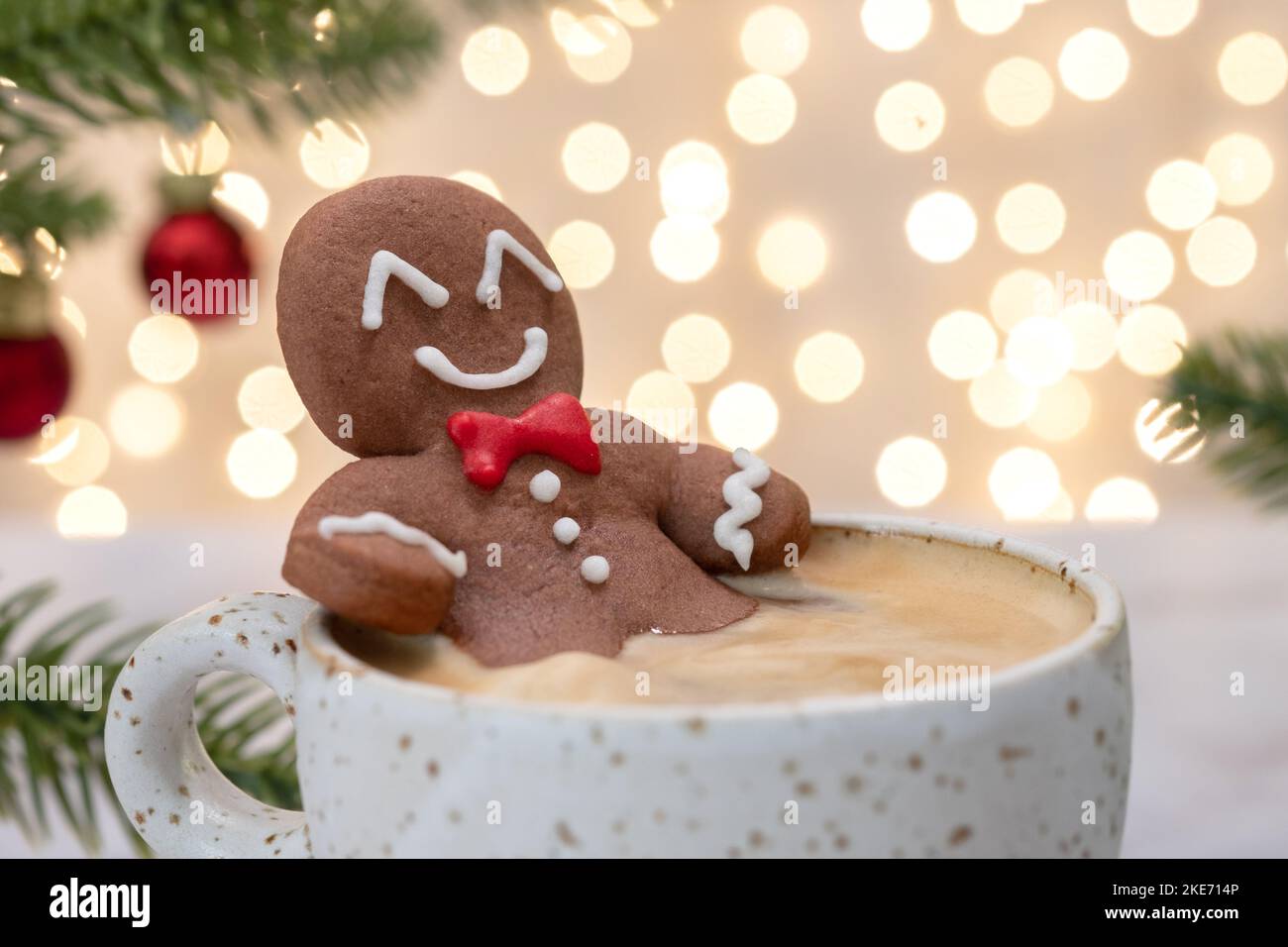 Gingerbread cookie man in a hot cup of cappuccino Stock Photo