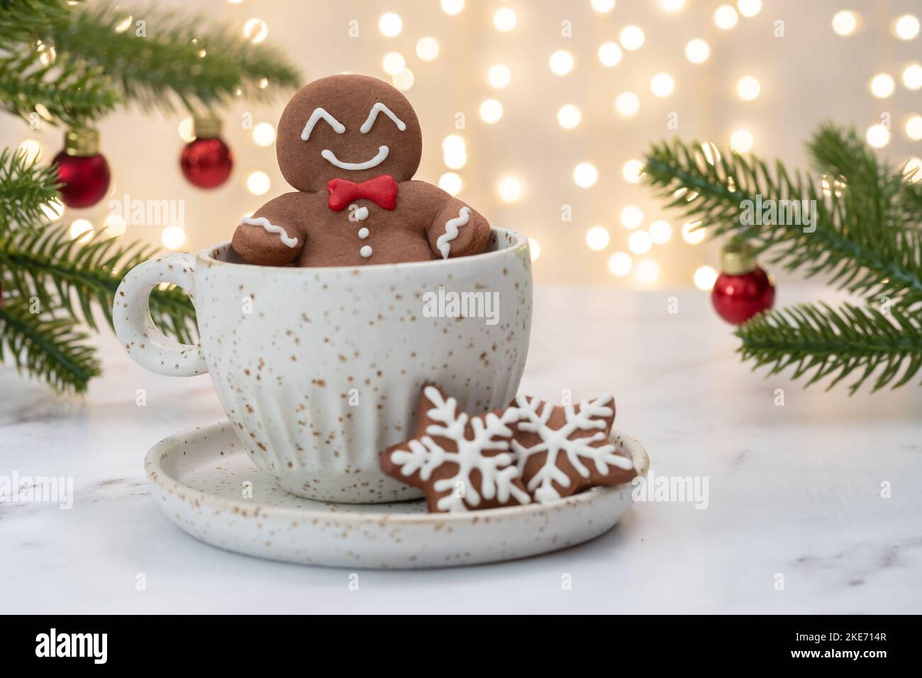 Gingerbread cookie man in a hot cup of cappuccino Stock Photo