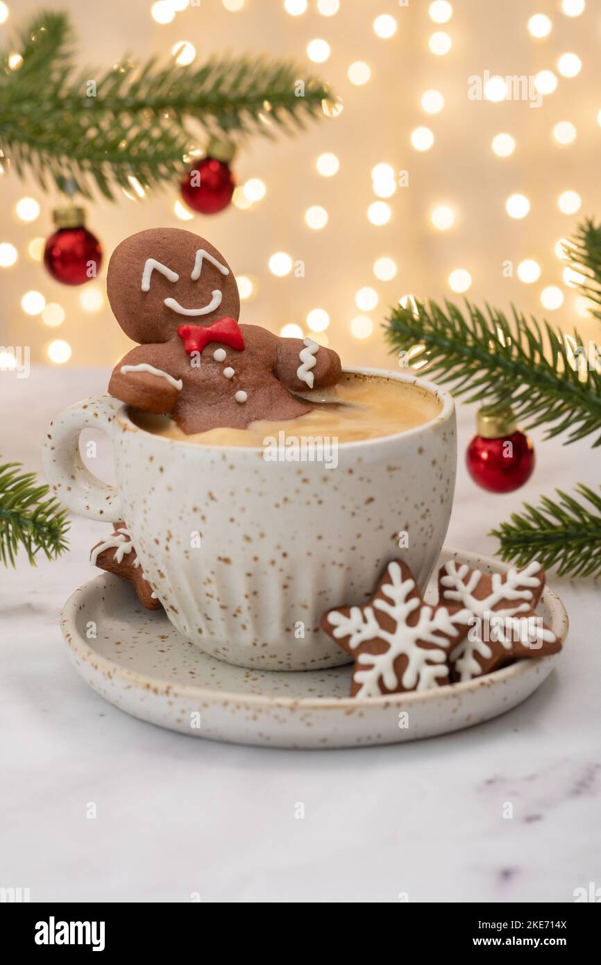 Gingerbread cookie man in a hot cup of cappuccino Stock Photo