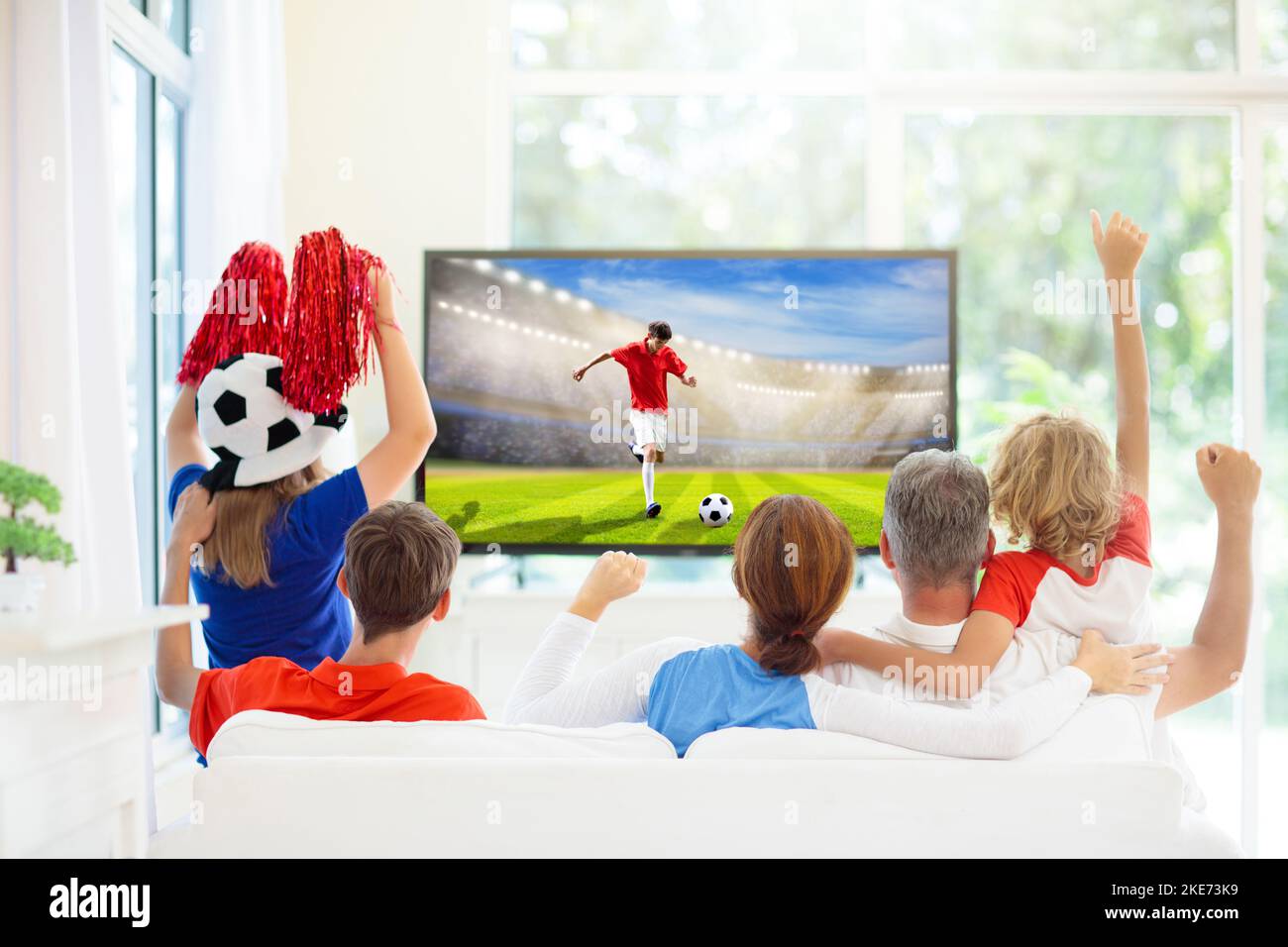 Group of football fans watch tv at home