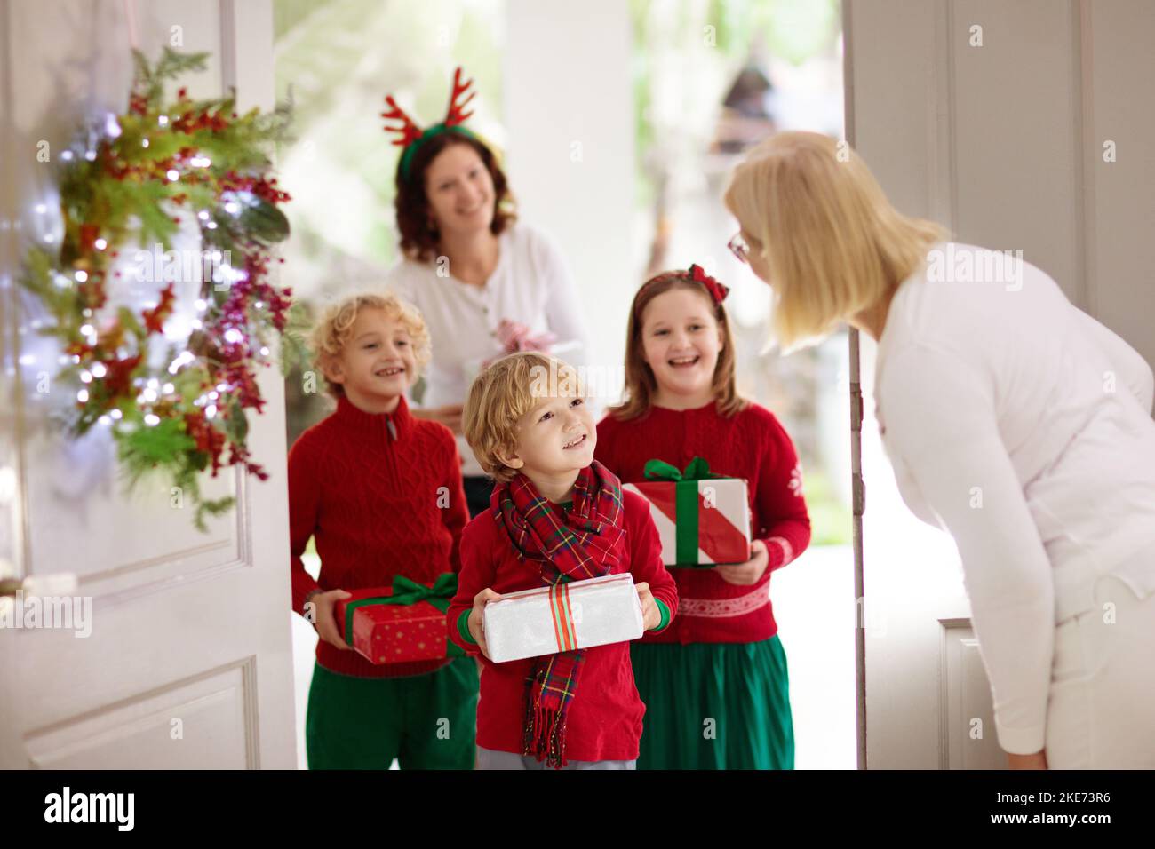 Family visiting grandmother on Christmas day. Kids with gifts at home ...