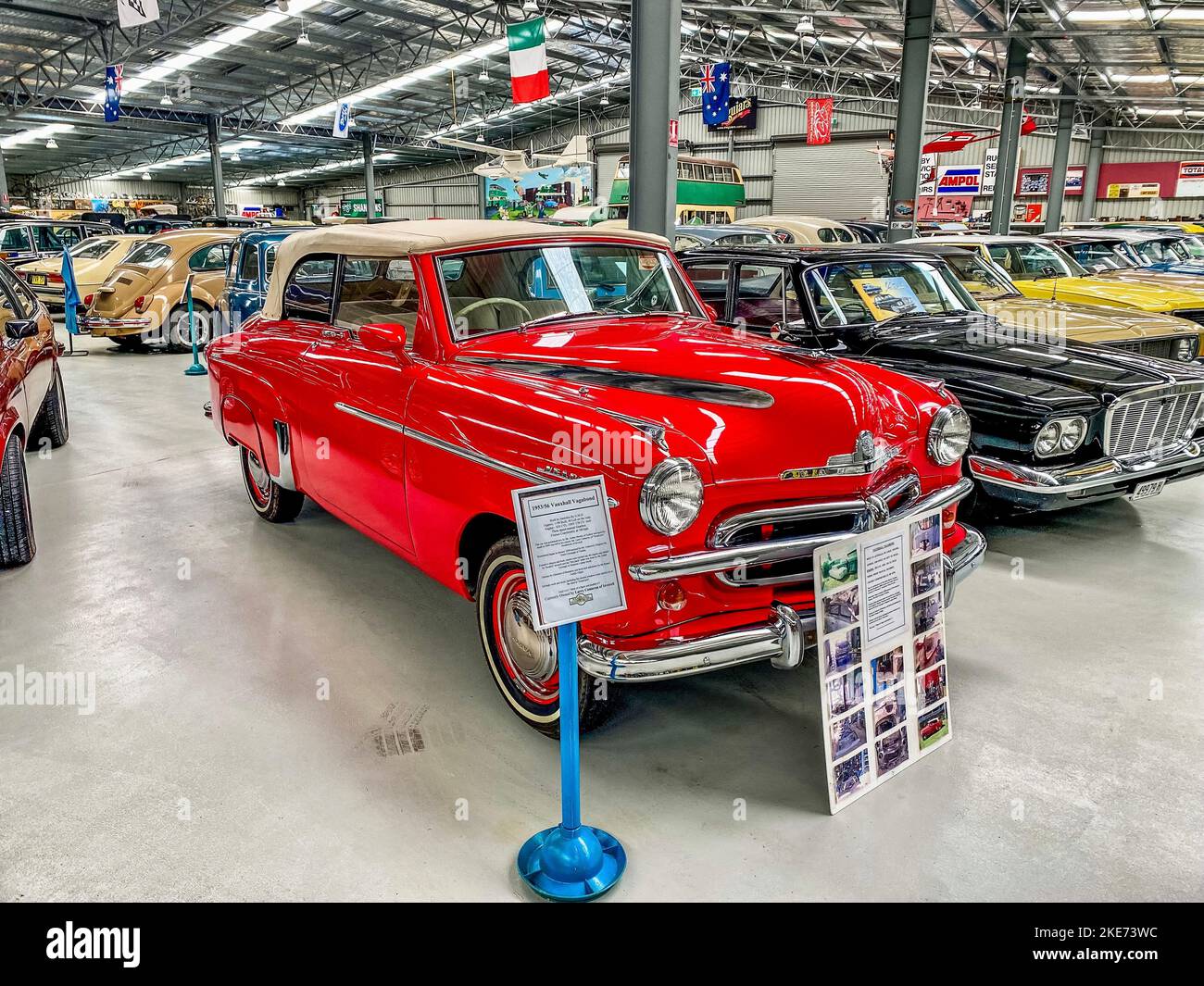 A front closeup of a red Vauxhall Vagabond on display with other