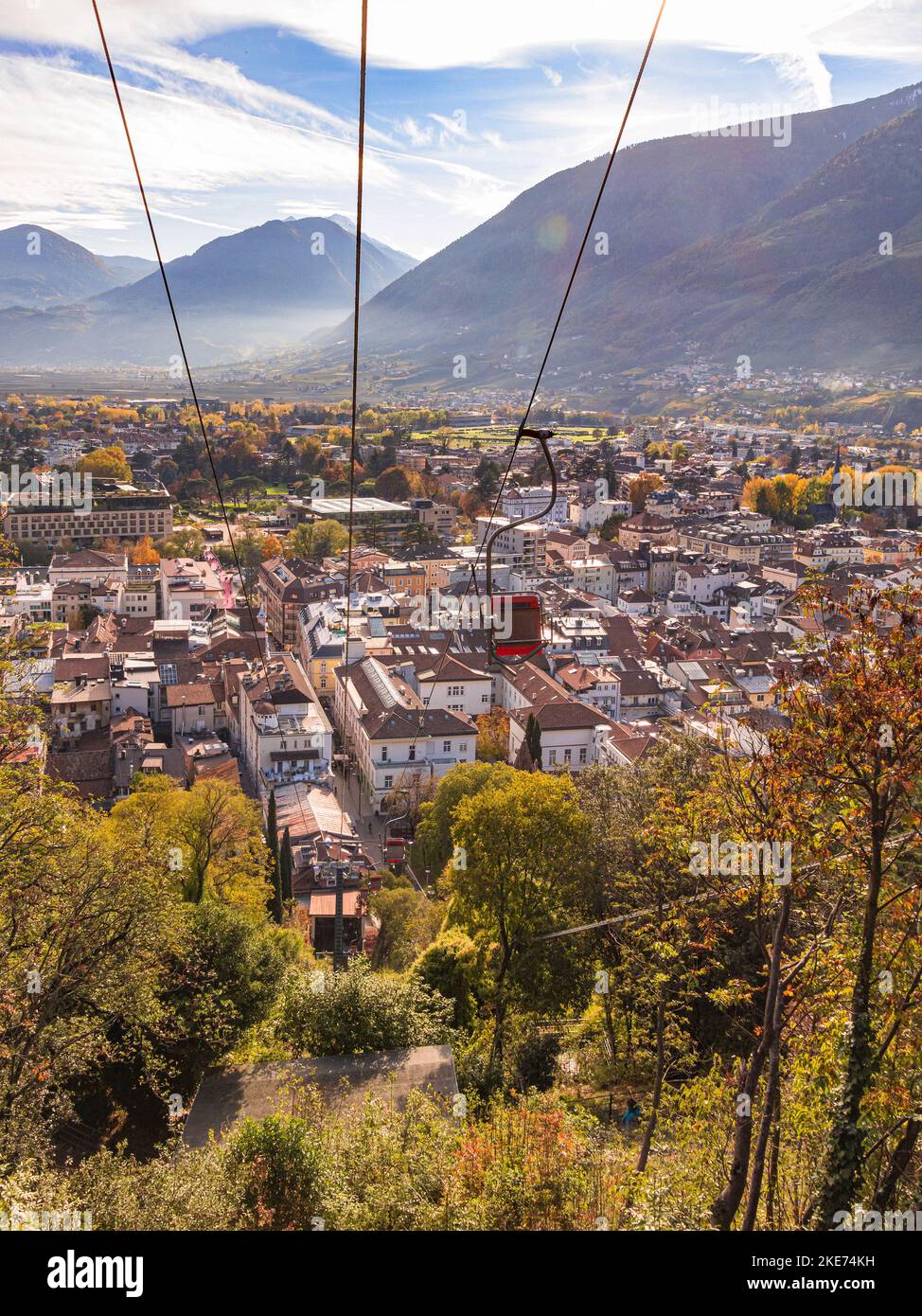 View from famous hiking trail Tappeinerweg over chairlift and cityscape of Merano, South tyrol, Italy Stock Photo
