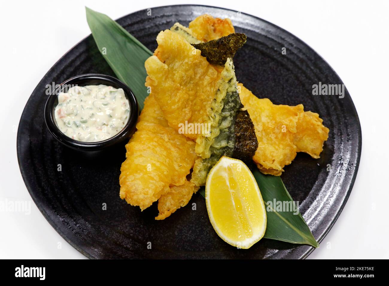 tempura battered crispy fried white fish sea bass with white background
