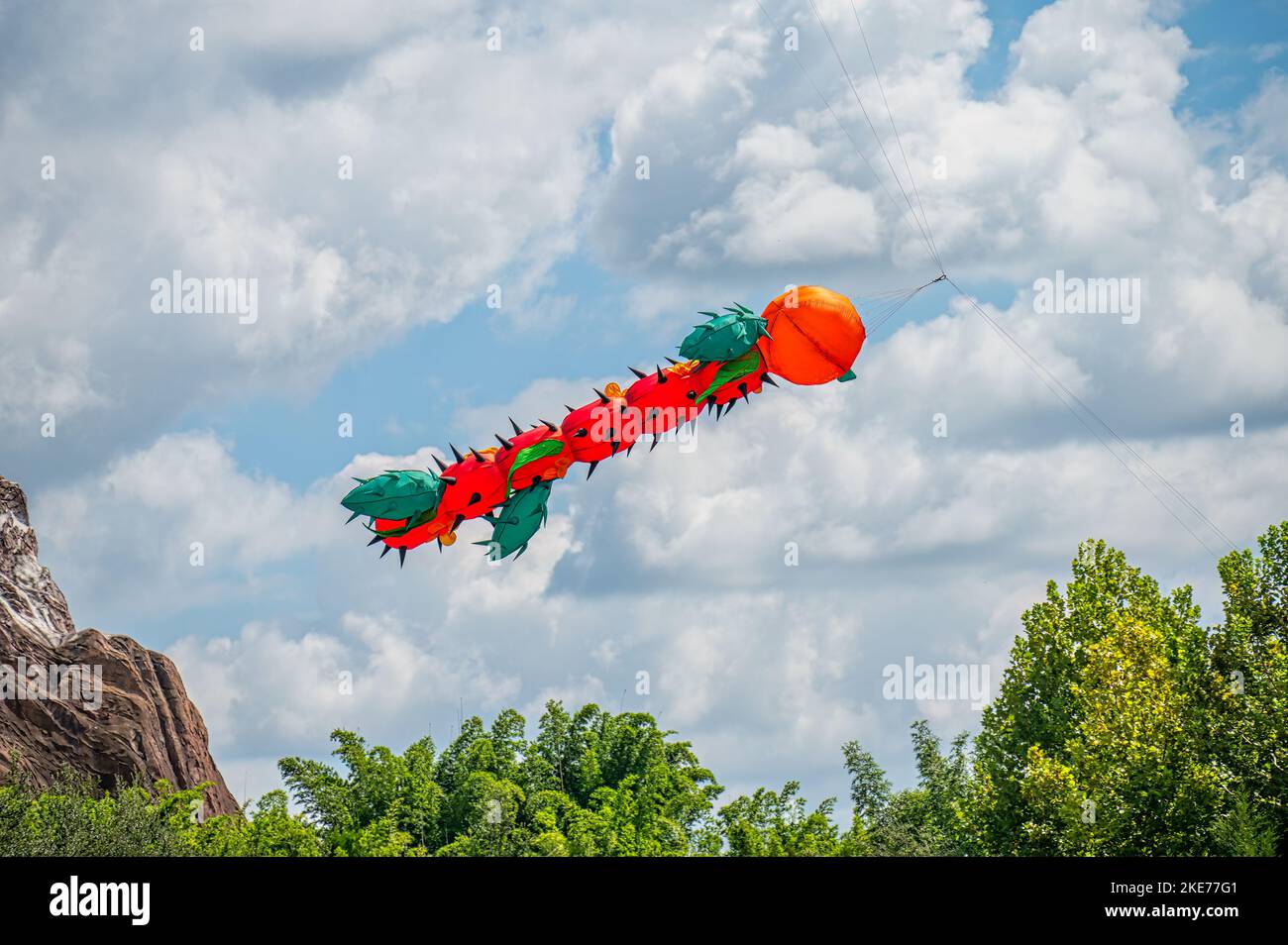 Large caterpillar shaped Kite flying through the air Stock Photo