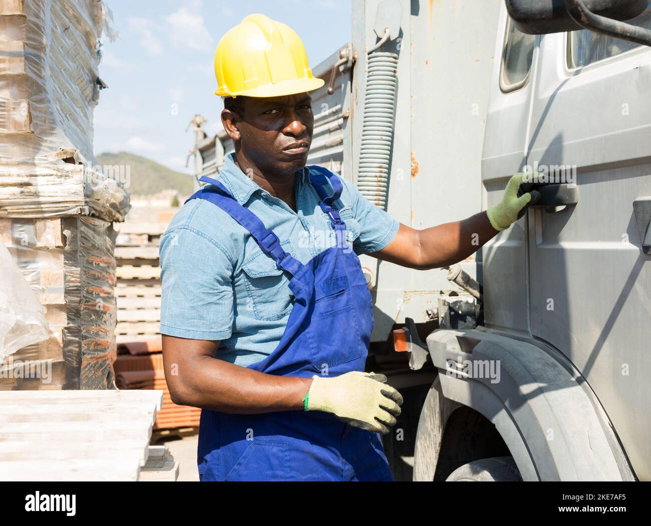 African american driver next to his truck at the construction site of hardware store Stock Photo