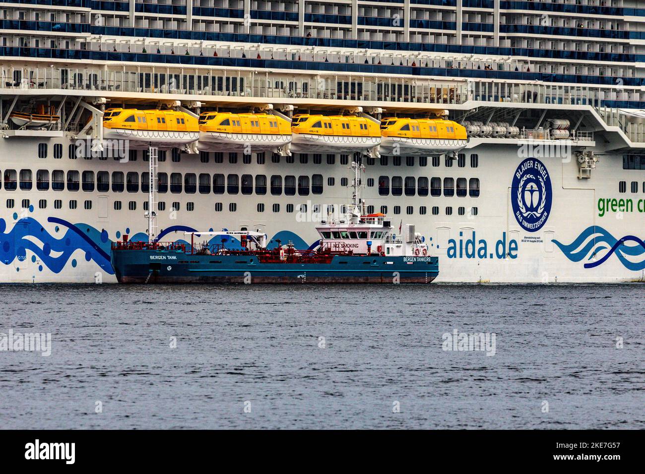 Cruise ship Sky AIDAnova at Jekteviken terminal in port of Bergen, Norway, getting ready for departure. Bunkering tanker Bergen Tank alongside Stock Photo