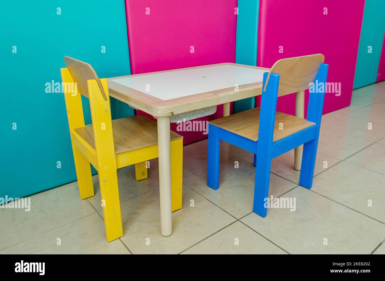 https://c8.alamy.com/comp/2KE8202/multicolored-kids-table-and-chairs-wooden-furniture-set-special-education-study-place-for-toddlers-in-an-occupational-therapy-classroom-2KE8202.jpg