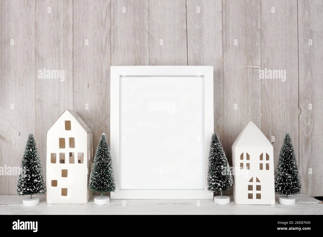 Christmas mock up with white frame, white houses and tree decor ...
