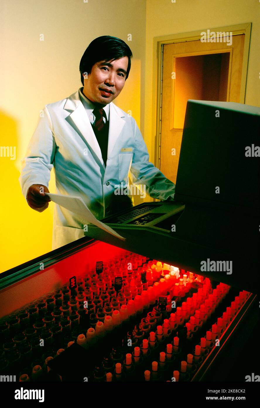 Environmental portrait of Asian male biomedical research scientist in his laboratory Stock Photo