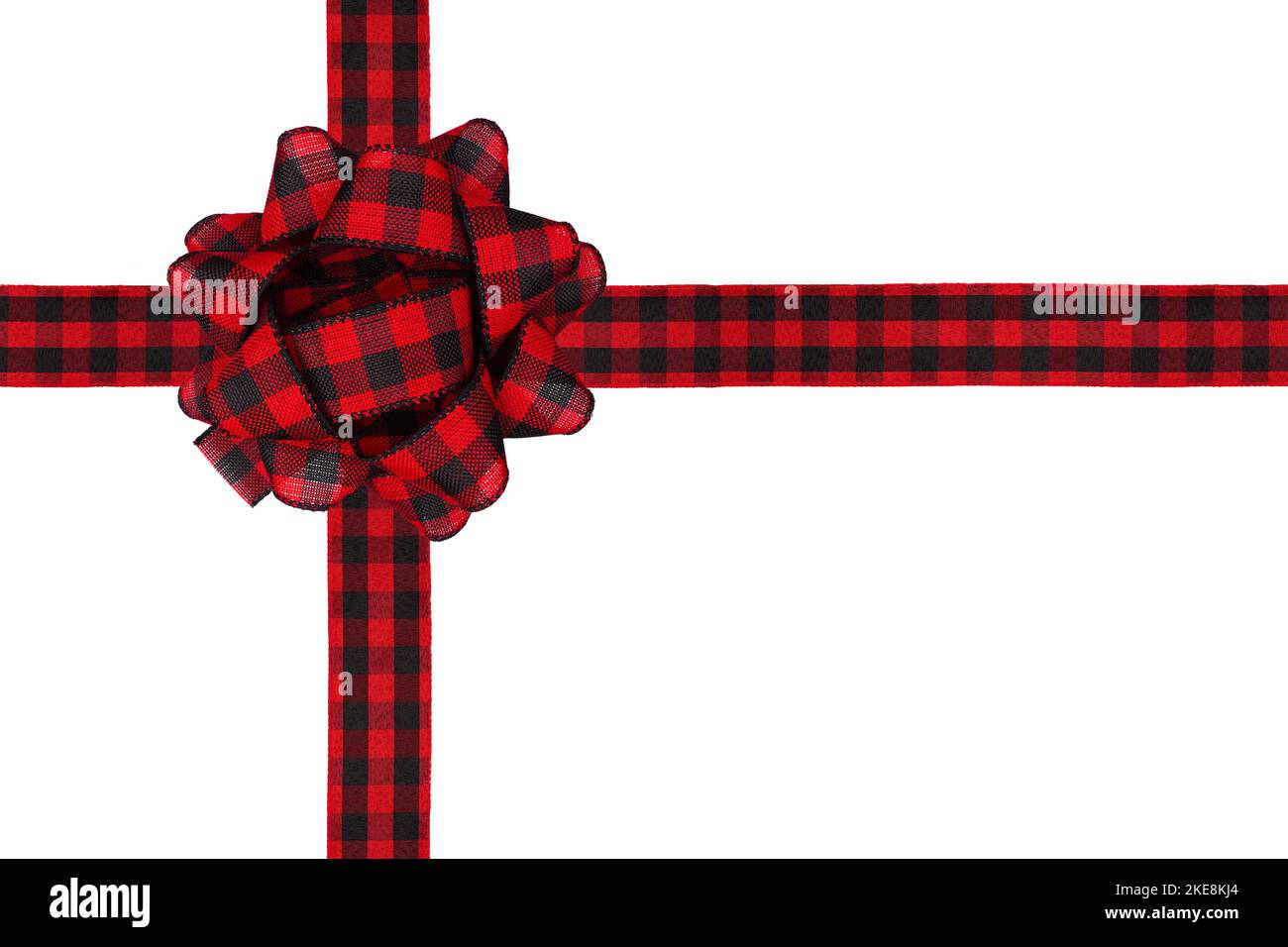 Christmas gift bow and ribbon with red and black buffalo plaid pattern. Box shape isolated on a white background. Stock Photo