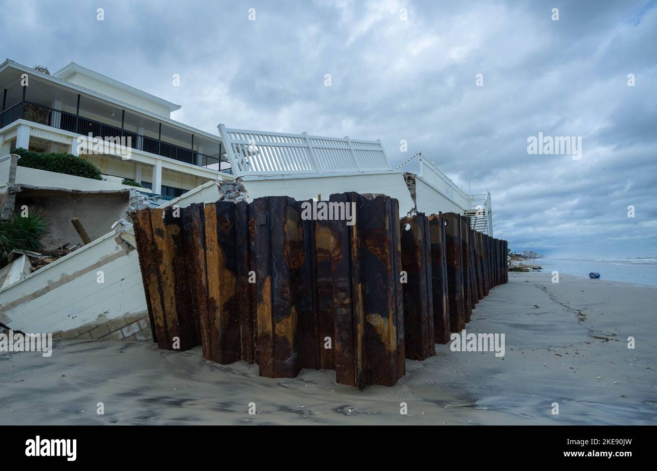 A rusted sea wall sits exposed after dune destruction from Hurricane Nicole. Several homes along South Atlantic Avenue saw serious damage from Nicole. Stock Photo