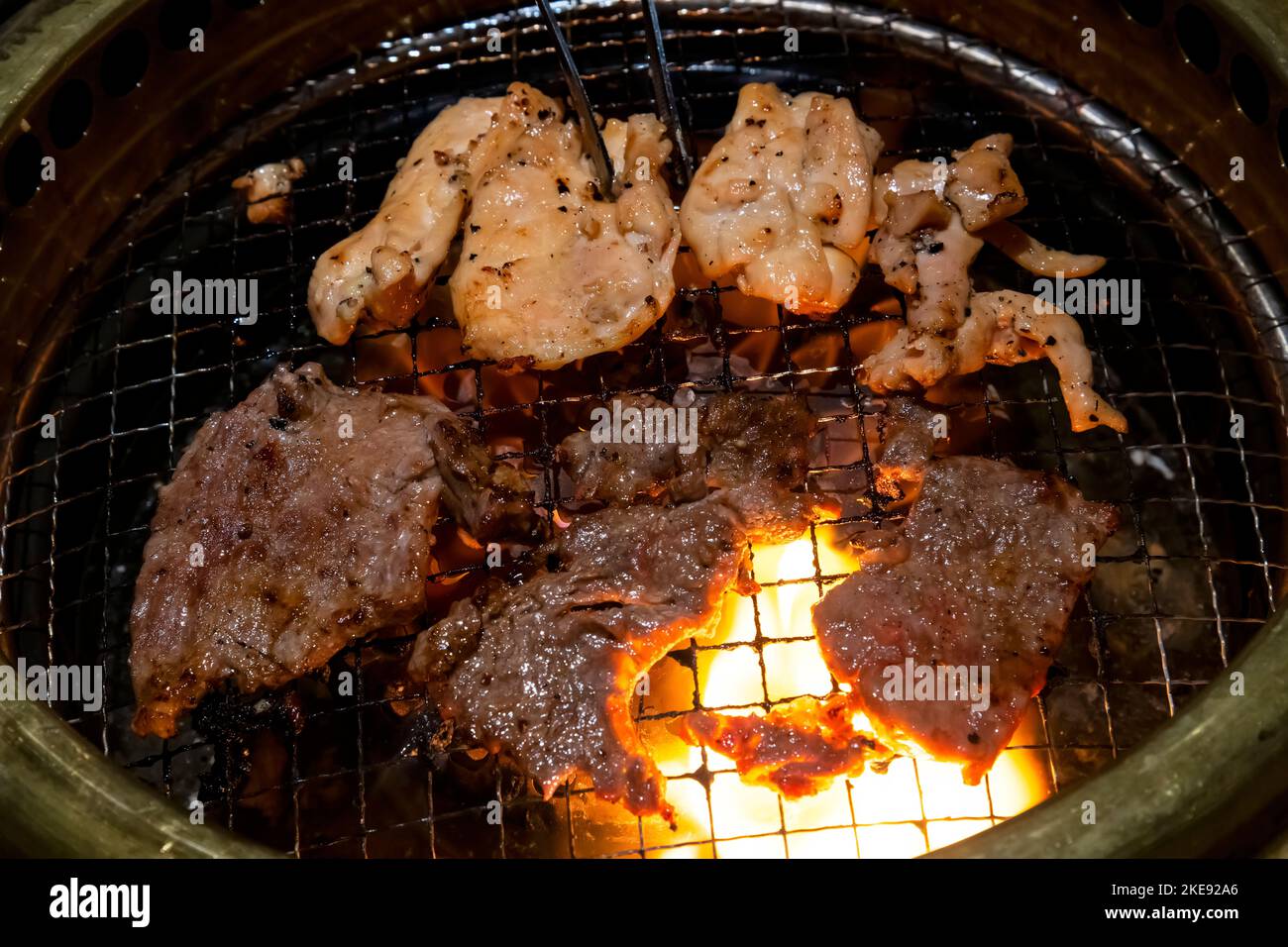 Korean BBQ restaurant, grilling Chicken and Beef. Stock Photo