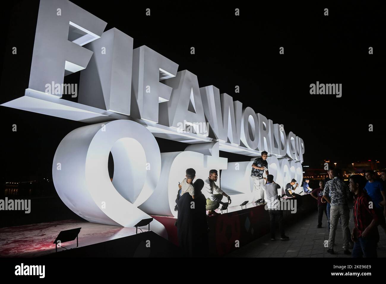 Doha, Qatar. 10th Nov, 2022. People take photos in front of a FIFA