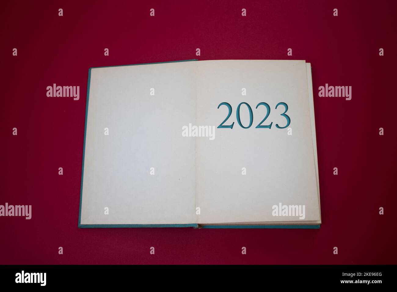 The number 2023 in opened book with vintage, natural patterns old antique paper design. Stock Photo