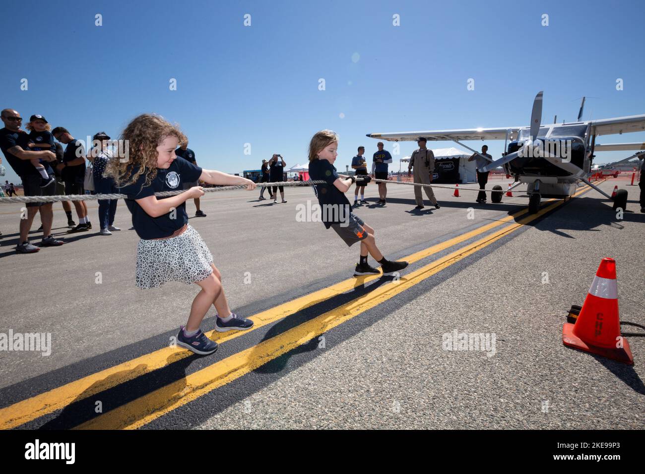 A girl and boy pull a small plane at the Special Olympics of Southern ...