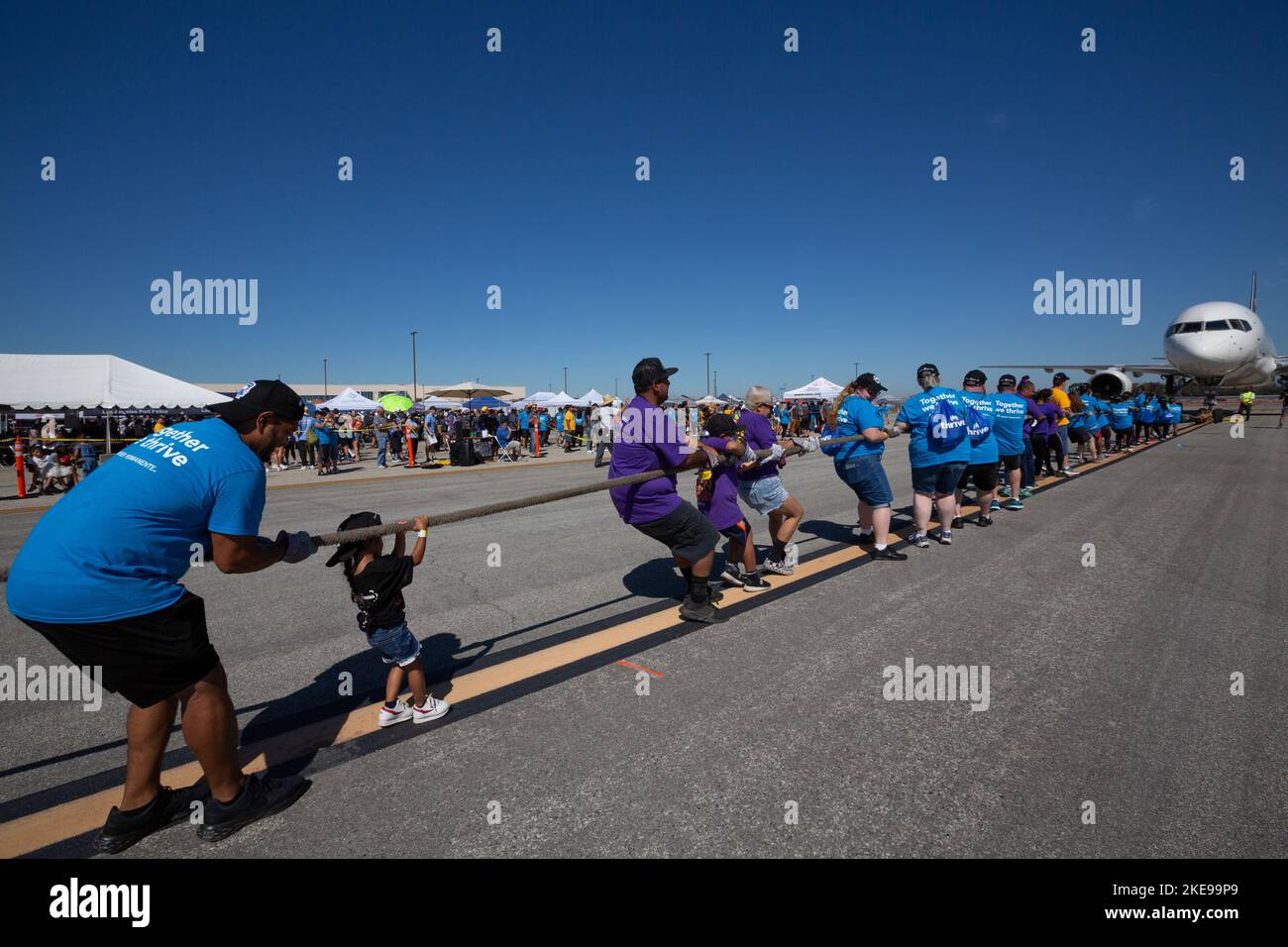 A pre-K child pulls with the team pulling a UPS airplane at the Special ...