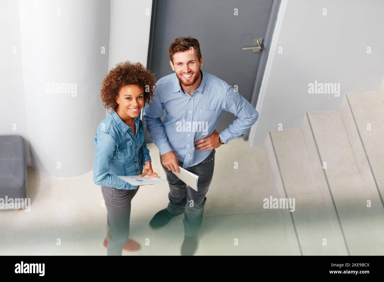 Were determined to overcome any challenge. two colleagues standing together in an office. Stock Photo