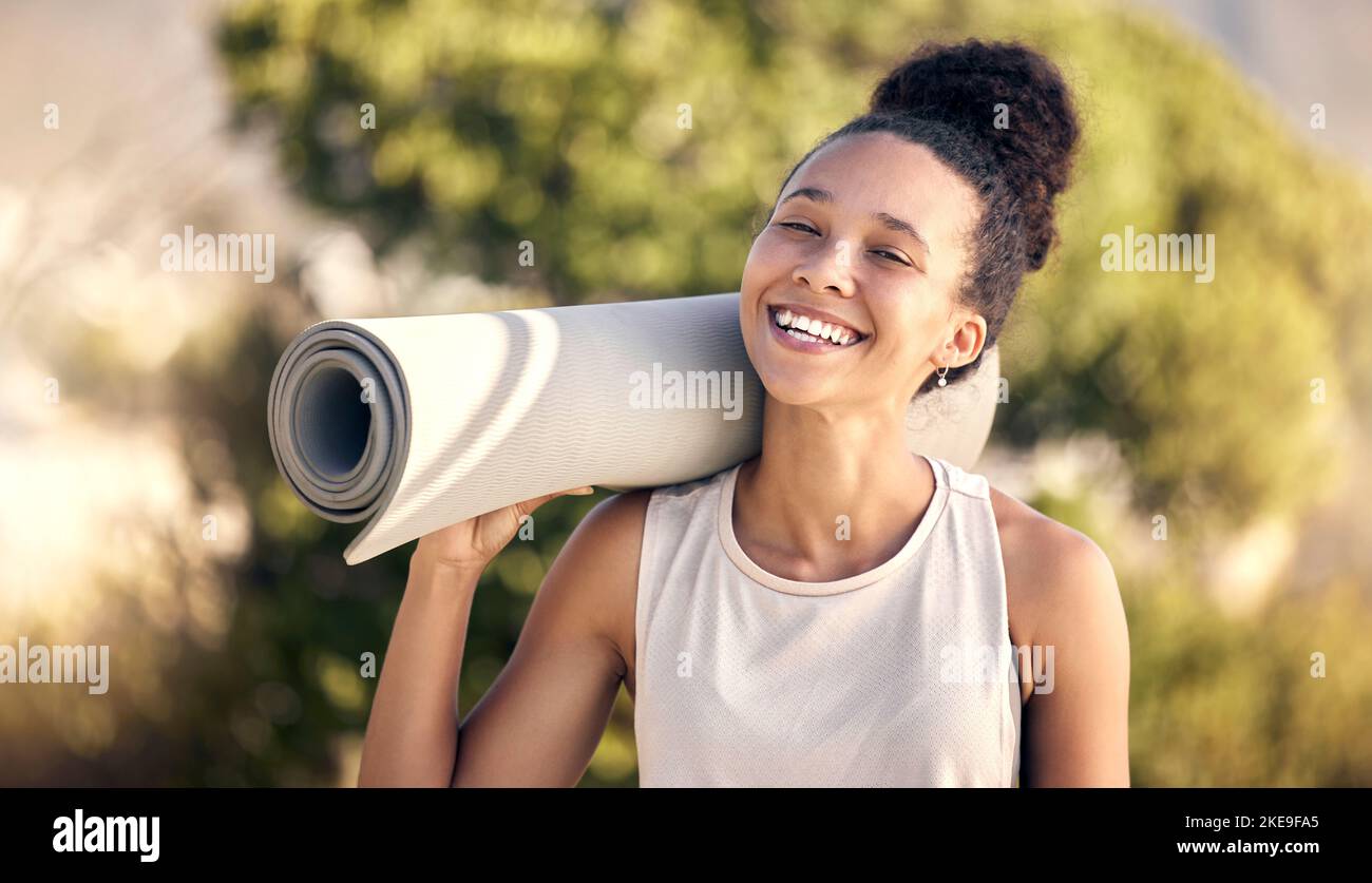Pilates, yoga mat and nature portrait of black woman ready to start health fitness, wellness exercise or outdoor workout. Peace, freedom or happy girl Stock Photo