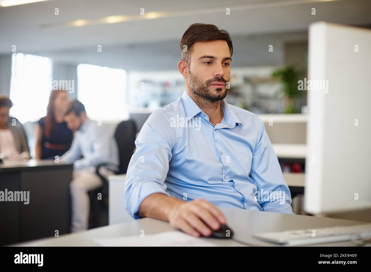 Work is where youre logged on. a businessman using a computer at his work desk. Stock Photo