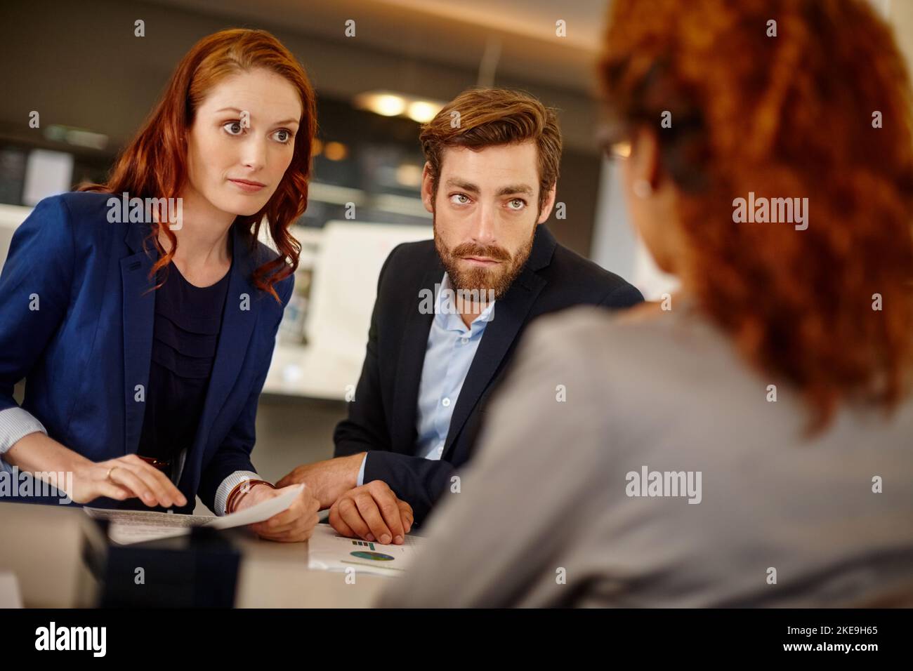 Tackling business head on. colleagues having a face to face meeting with a woman at work. Stock Photo
