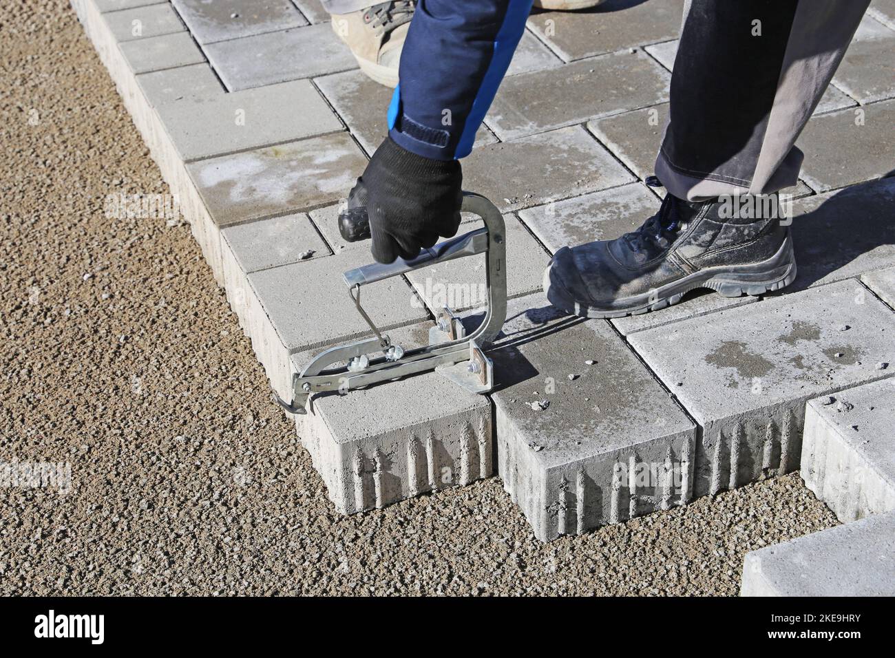 Construction worker lay paving stones Stock Photo
