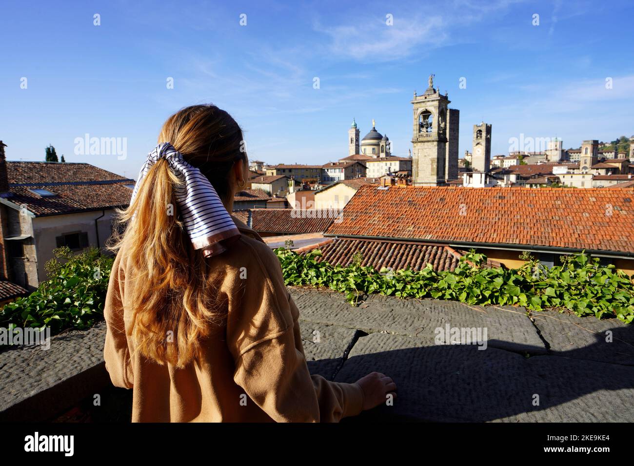 Rear view of girl looking the cityscape of Bergamo, Lombardy, Italy Stock Photo