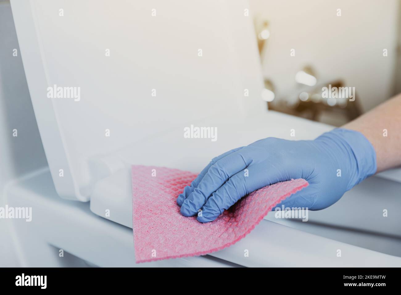 Close up on woman hand gloved in blue rubber protective gloves