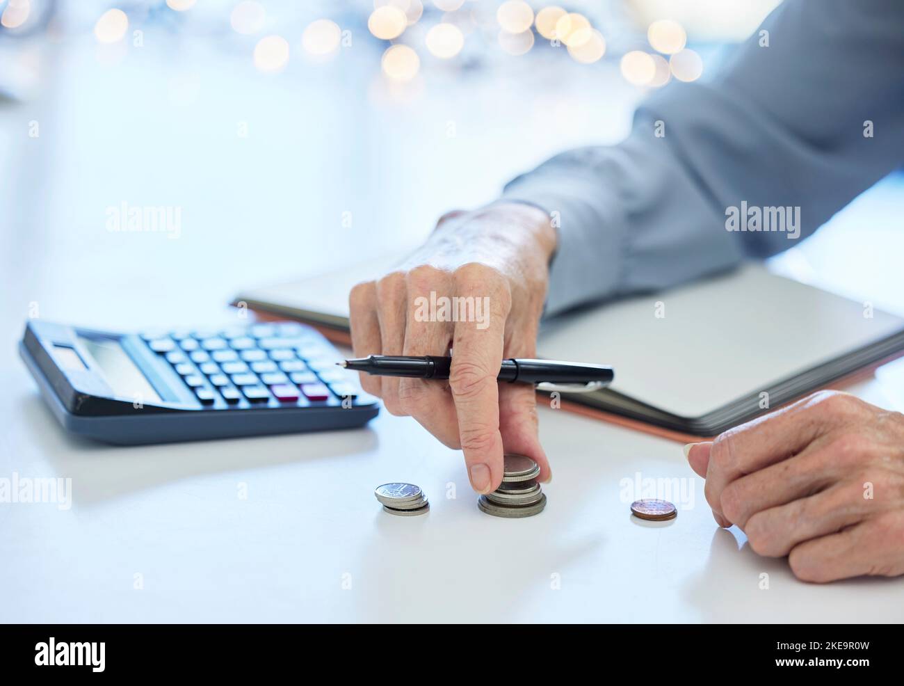 Budget, coin and business hands with calculator for inflation, savings and commerce financial planning. Money, cash and change for finance management Stock Photo