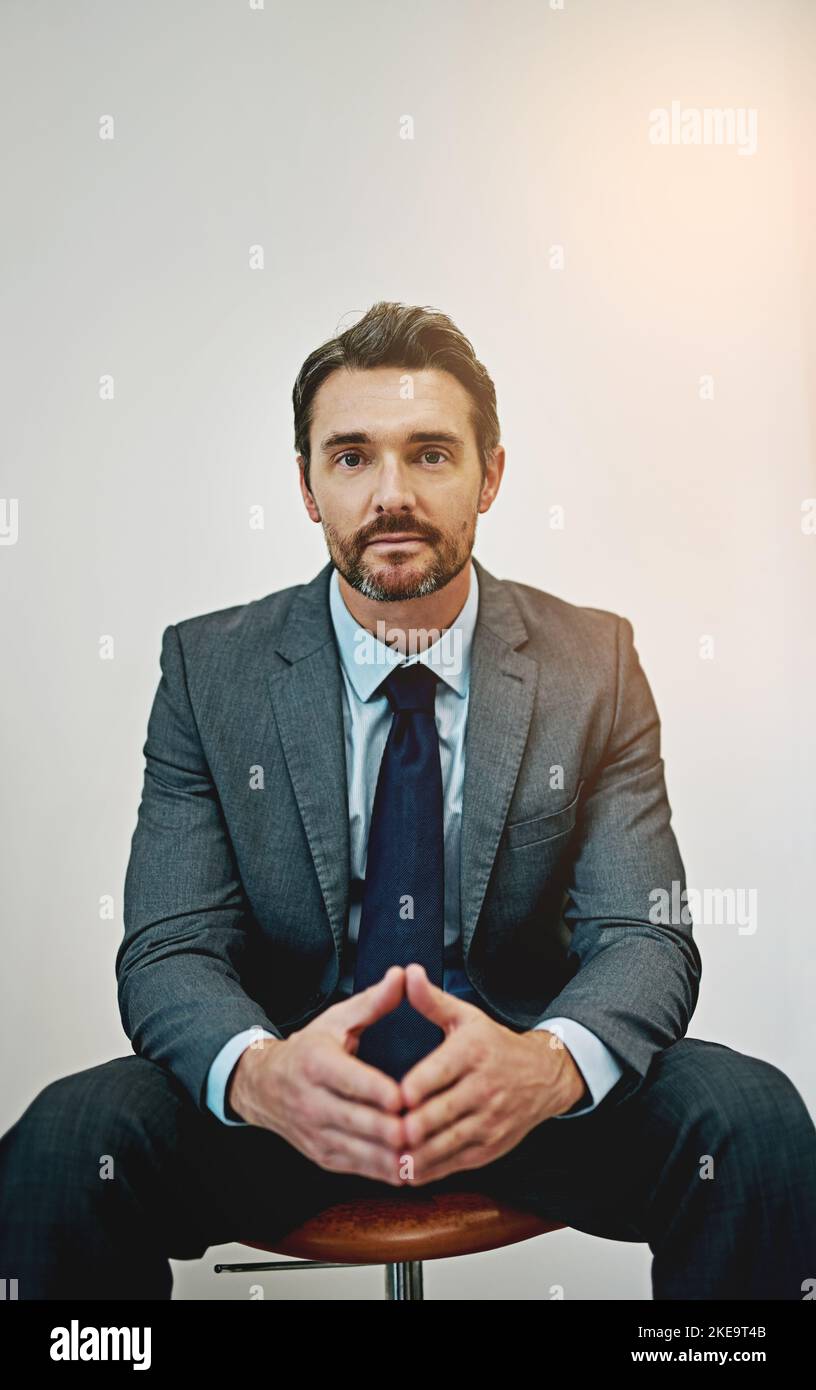 Professionalism is a big part of his personal brand. Portrait of a confident and mature businessman in an office. Stock Photo