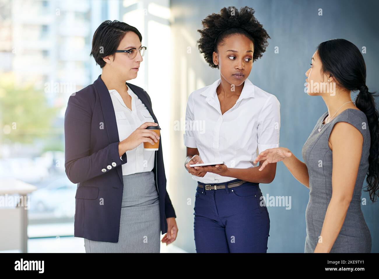 Whos the boss. three businesswomen talking in the office Stock Photo ...