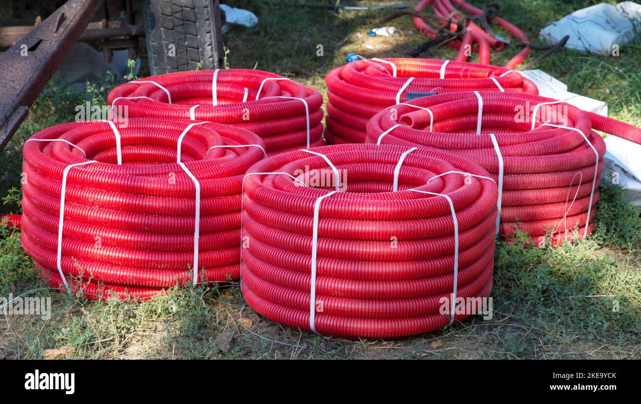 Reel of red pipe made of plastic on the ground Stock Photo Alamy