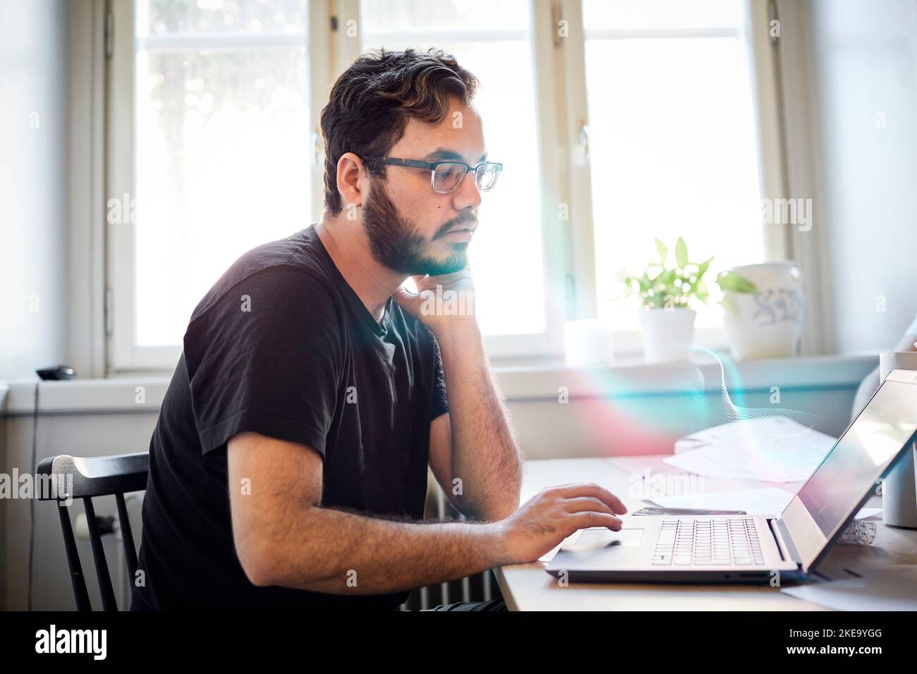 Man reading fake news on computer Stock Photo