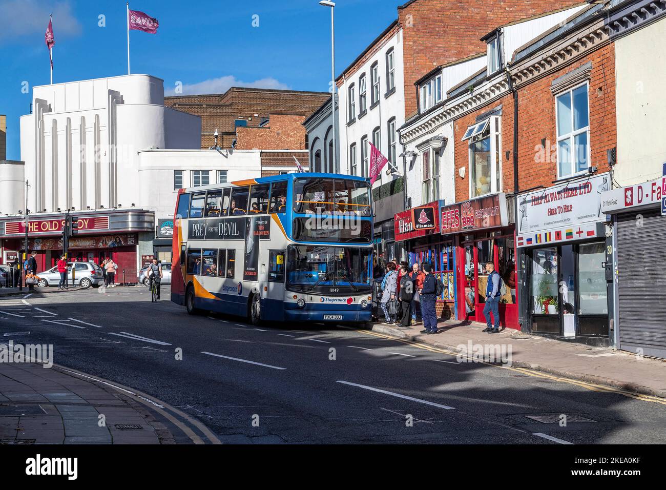 Bus picking up passengers in York road near The Old Savoy theatre, Northampton, England, UK