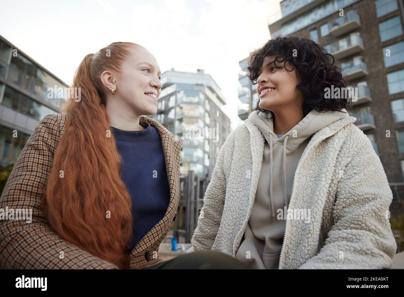Young female friends talking outdoors Stock Photo