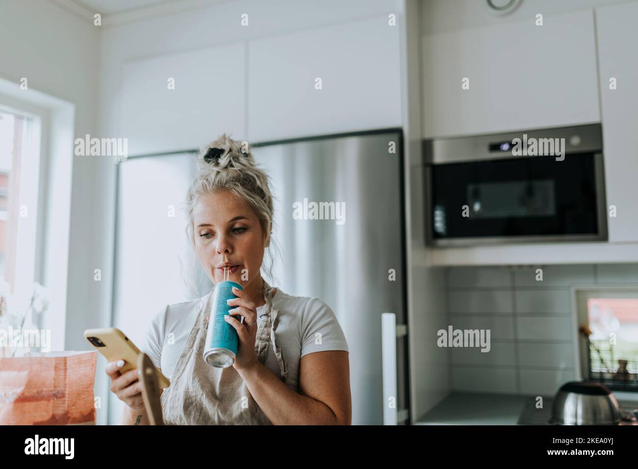 Smiling woman in kitchen Stock Photo