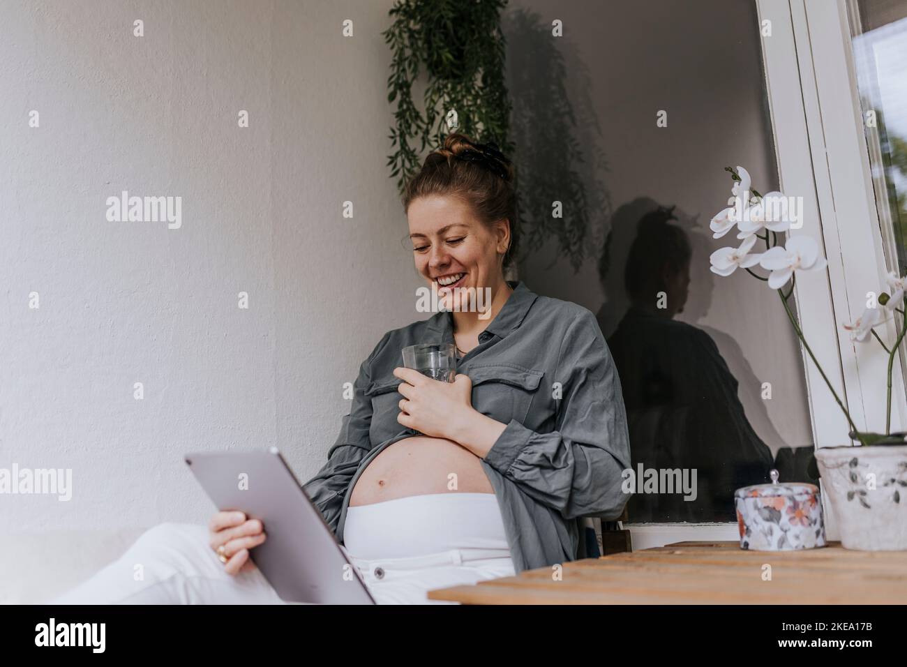 Pregnant woman using digital tablet Stock Photo