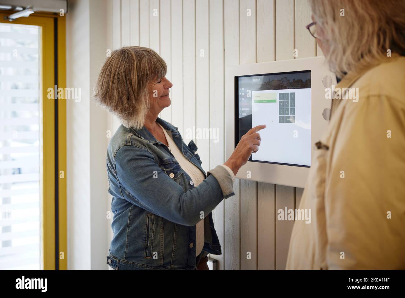 Woman entering block of flats Stock Photo - Alamy