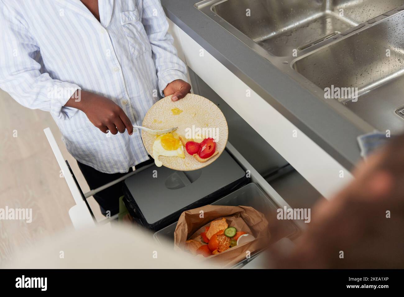Boy throwing out leftover food Stock Photo Alamy